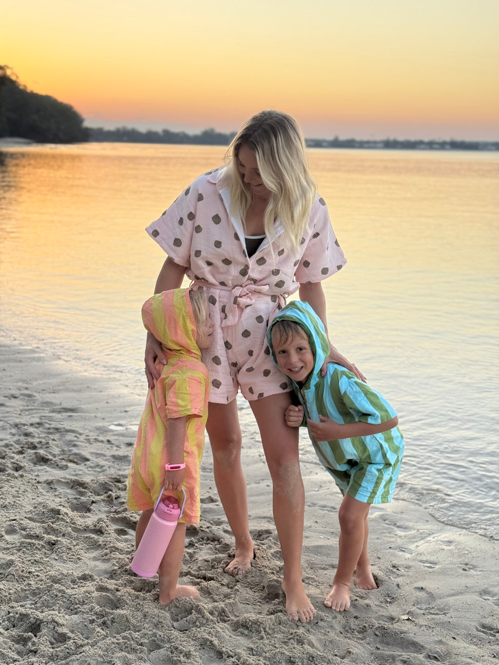 Woman wearing brown patterned towel-wear. This wearable towel is made from Organic Cotton and a towel outfit.