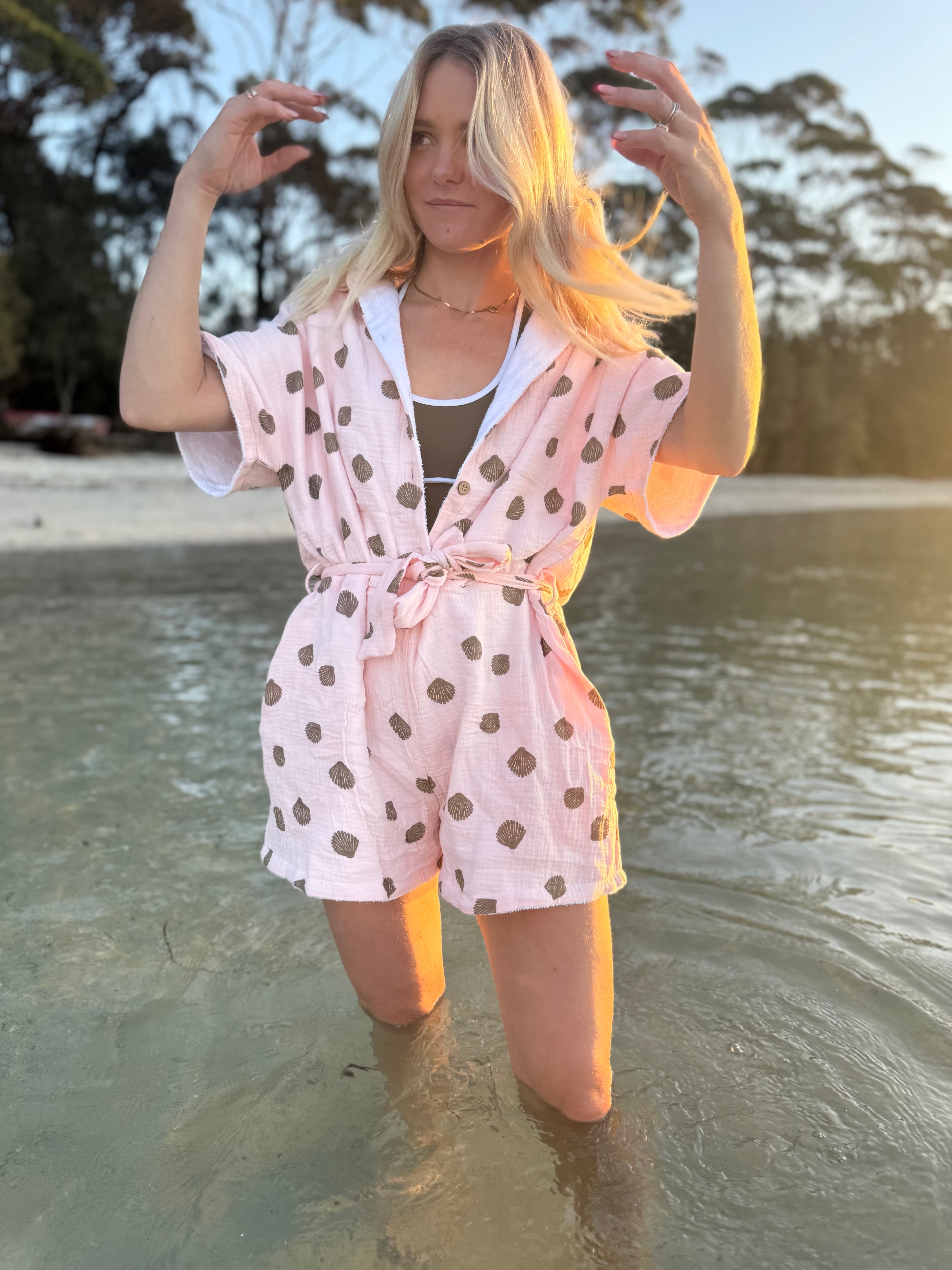 Woman wearing brown patterned towel-wear. This wearable towel is made from Organic Cotton and a towel outfit.