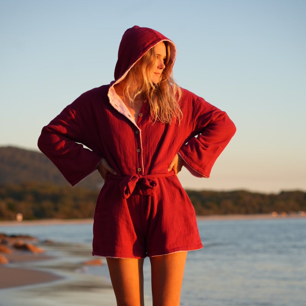 Woman wearing brown patterned towel-wear. This wearable towel is made from Organic Cotton and a towel outfit.