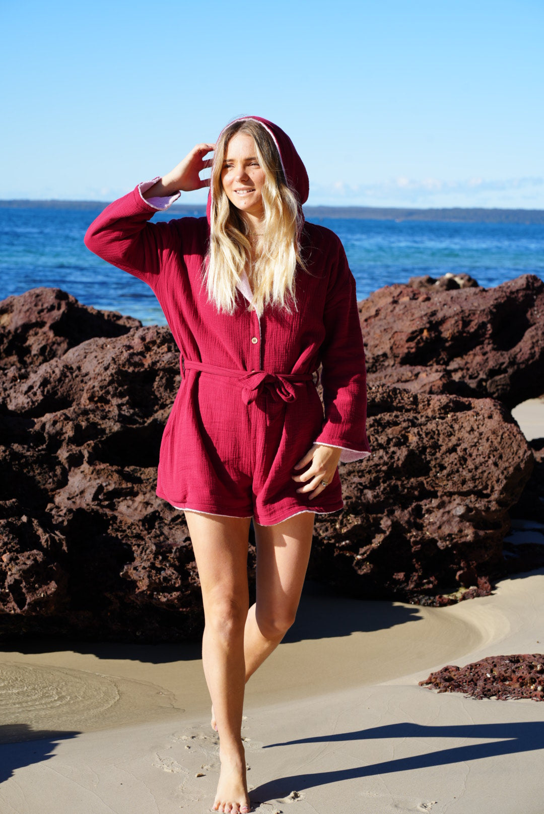 Woman wearing brown patterned towel-wear. This wearable towel is made from Organic Cotton and a towel outfit.