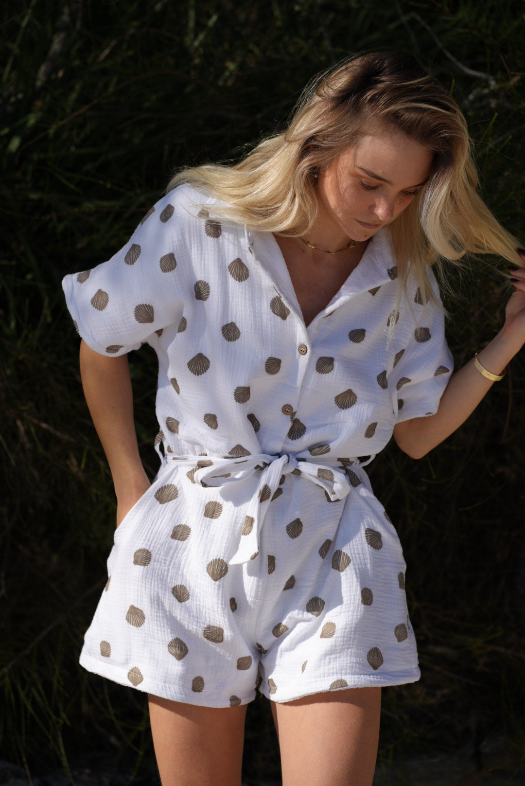 Woman wearing brown patterned towel-wear. This wearable towel is made from Organic Cotton and a towel outfit.