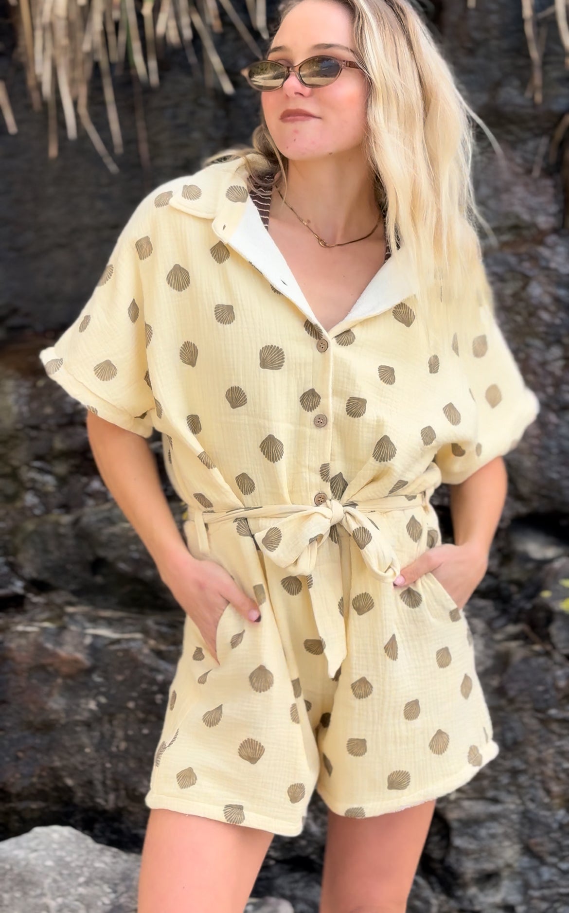 Woman wearing brown patterned towel-wear. This wearable towel is made from Organic Cotton and a towel outfit.